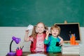 Back to school. Cute little preschool kid boy with Little child girl play with paper airplane in a classroom. Little Royalty Free Stock Photo