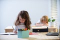 Back to School. Cute pupil writing at desk in classroom at the elementary school. Student girl doing test in primary Royalty Free Stock Photo