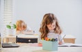 Back to School. Cute pupil writing at desk in classroom at the elementary school. Student girl doing test in primary Royalty Free Stock Photo