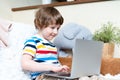 Back to school. Distance learning online education. Caucasian smile preschooler kid boy studying at home with laptop notebook and Royalty Free Stock Photo