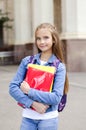 Back to school. Education concept. Cute smiling schoolgirl preteen on the way to the school