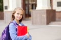 Back to school. Education concept. Cute smiling schoolgirl preteen on the way to the school