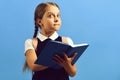 Back to school and education concept. Girl holds blue book