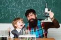 Back to school and Education concept. Teacher and child - learning at home. Father and son. Lab microscope and testing Royalty Free Stock Photo