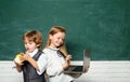 Back to school. Education. Happy smiling pupils drawing at the desk. Boy and girl from elementary school at the school