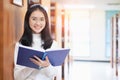 Back to school education knowledge college university concept, Beautiful female college student holding her books smiling happily Royalty Free Stock Photo