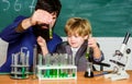 Back to school. Explaining biology to child. father and son at school. biotechnoloy research concept. Chemistry and