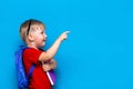 Back to school First grade junior lifestyle. Small boy in red t-shirt. Close up studio photo portrait of smiling boy in glasses