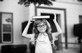 Back to school. Funny little boy in glasses at school. Child from elementary school with book and bag. Education child. Royalty Free Stock Photo