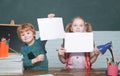 Back to school. Funny little kids pointing up on blackboard - school concept. Education. Paper copy space. Royalty Free Stock Photo