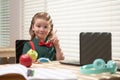 Back to school. Funny school boy from elementary school with book and laptop. Education. Kid with school supplies. Royalty Free Stock Photo