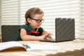 Back to school. Funny school boy from elementary school with book and laptop. Education. Kid with school supplies. Royalty Free Stock Photo