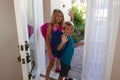 Back to school: Girl and boy walking out the front door Royalty Free Stock Photo