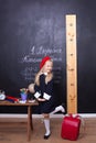 Back to school! The girl at school stands near the board. School concept. Schoolgirl answers at a lesson. On the chalkboard in Ukr