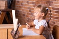 Back to school: girl is sitting at a school desk and studying math. The child is doing homework. Preschool education Royalty Free Stock Photo