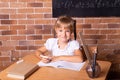 Back to school: girl is sitting at a school desk and studying math. The child is doing homework. Preschool education, self Royalty Free Stock Photo