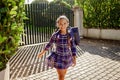 Back to school. Girl with backpack goes to school from home at the first day after vacation Royalty Free Stock Photo