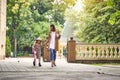 Back to school. Happy mother and daugther go to elementary school. Parent taking child to primary school