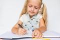 Back to school and happy time. Children holding pen and writting in notebook on white background. Kid making homework. Mockup, Royalty Free Stock Photo