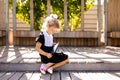 Back to school and happy time Cute industrious child sitting outdoors. Girl reading the book