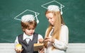 Back to school and happy time. Education first. Schoolgirl helping pupils studying at desks in classroom. Teacher Royalty Free Stock Photo