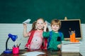 Back to school and happy time. Happy cute clever boy and cute little girl with toy paper airplane. First time to school Royalty Free Stock Photo