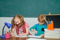 Back to school and happy time. Kid is learning in class on background of blackboard. Cute little preschool kid boy with Royalty Free Stock Photo