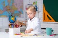 Back to school. Home school for pupil. Kid is learning in class on background of blackboard. First school day. Kids Royalty Free Stock Photo