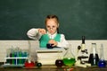 Back to school and home schooling. Kid is learning in class on background of blackboard. School concept. Royalty Free Stock Photo