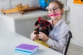 Back to school idea concept with funny dog holding pencil. Smart and clever dog with pencil and glasses. Royalty Free Stock Photo