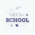 Back to school inscription on the checkered school notebook background with hand drawn paper plane and autumn leaves Royalty Free Stock Photo