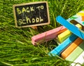 Back to school, the inscription on the mini-Board, the layout of the Board and chalk on the green grass, the concept of Royalty Free Stock Photo