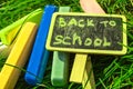 Back to school, the inscription on the mini-Board, the layout of the Board and chalk on the green grass, the concept of Royalty Free Stock Photo