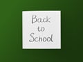 Back to school inscription on white sheet on green board background Royalty Free Stock Photo
