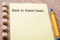 Back to School Items concept on notebook and wooden board