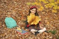 back to school. kid with notebook. fall season fashion. teen girl in uniform hold autumn leaves. Royalty Free Stock Photo