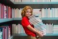 Back to school. Kid reads books in the library. Schoolboy with book in school library. Literature for reading. Child Royalty Free Stock Photo