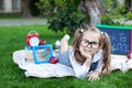 Back to school. The kid is ready for school. smart child little girl in glasses with school supplies a school board, books, a magn Royalty Free Stock Photo