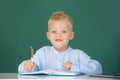 Back to school. Kid writing in class. Little student child studying in classroom at elementary school. Royalty Free Stock Photo