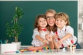 Back to school. School kids drawing with teacher. Children from elementary school study at draw lesson. Pupils girl and