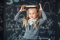 Back to school. little blond girl in school uniform child from elementary school keeps a books on her head. education. child with Royalty Free Stock Photo