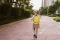 Back to school. Little girl with yellow backpack from elementary school outdoor. Kid going learn new things 1th Royalty Free Stock Photo