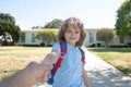 Back to school, lovely schoolboy holding parent fathers hand on the way to the school. Concept of primary school Royalty Free Stock Photo