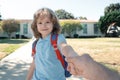 Back to school, lovely schoolboy holding parent fathers hand on the way to the school. Concept of primary school Royalty Free Stock Photo