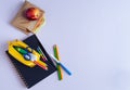 Back to School Material. Pencils, notebook and sandwich on purple background Royalty Free Stock Photo