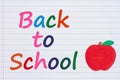 Back to School message with an apple on vintage ruled line notebook paper