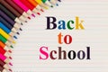 Back to School message with color pencils on vintage ruled line notebook paper