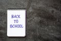 `Back to school` message written in a notebook on slate background. Royalty Free Stock Photo