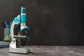 Back to school. Microscope  on black background. Studying biology at school laboratory Royalty Free Stock Photo