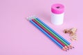 Back to school. Pencils, pencil sharpener on bright pink background. Place for text. Royalty Free Stock Photo